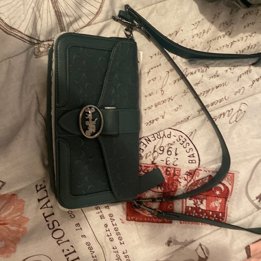 Beand new Coach purse. Still has ticket and packaging on it.